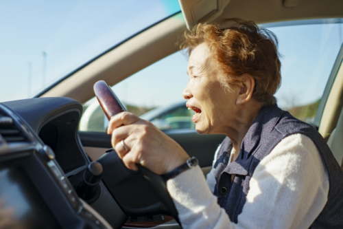 車を運転する高齢女性